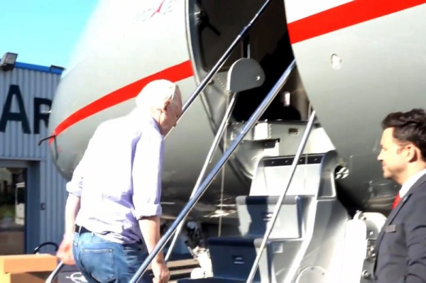 Julian Assange en-route to Saipan to appear in a U.S. court before flying home to Australia