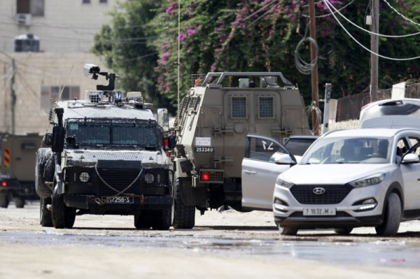 Israel's military launches manhunt in West Bank after gunmen kill three Israelis, injure eight